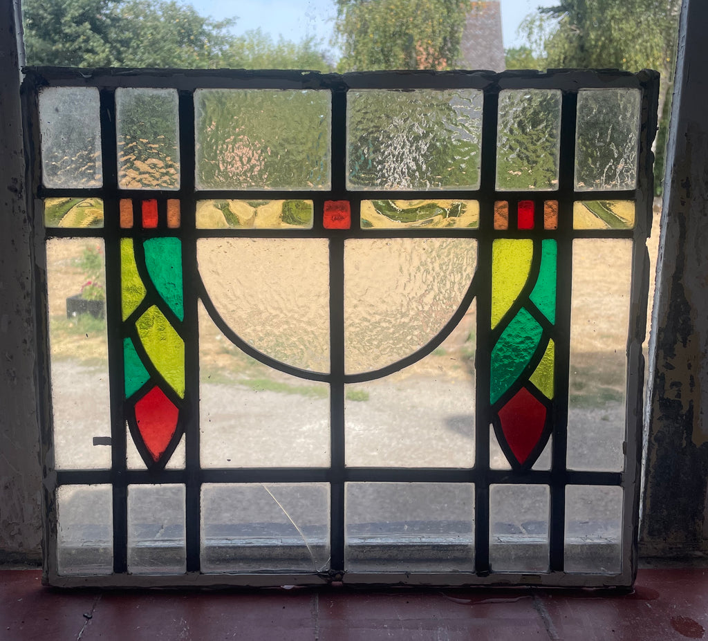 Antique British Arts and Crafts stained glass panel c.1900 with green, yellow and red geometric leaded glass
